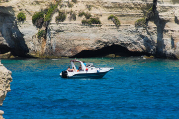 Tourist boat near the sea cliff. Torre Sant'Andrea, Salento coast, Apulia, ITALY