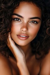 Obraz premium Beautiful latin model gently touching face with freckles and brown eyes