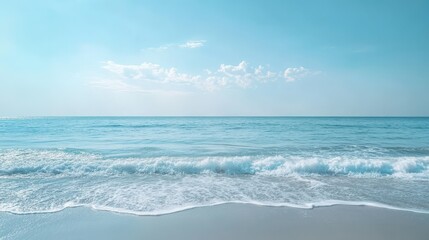 Calm ocean waves and clear sky at sandy beach