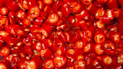 Sliced ​​red chili peppers. Food preparation. Background.
