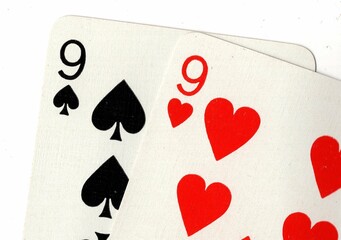 Close up of a hand of playing cards on a white background.