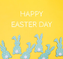 Yellow background with a group of green rabbits