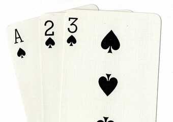 A hand of playing cards showing a run of ace, two and three in the same suit.