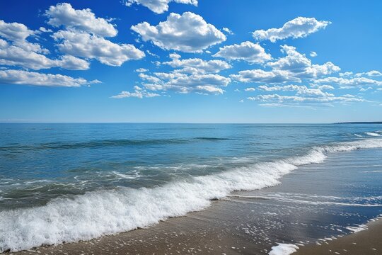 Calm waves lapping at the shore under a bright blue sky with scattered clouds in the late afternoon. Generative AI