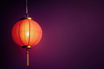 Obraz premium A Red Lantern Hanging Against A Dark Purple Background