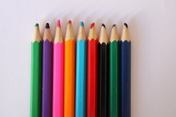 colored pencils on a white background