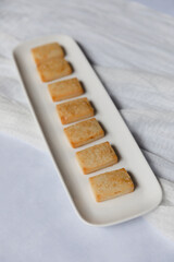 Homemade desserts on a white plate served at a cozy gathering in an inviting kitchen setting