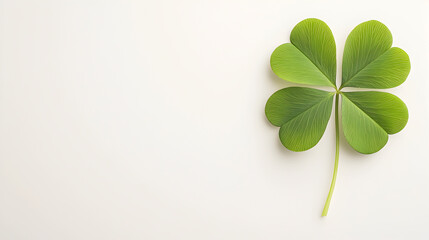 Large four-leaf clover with detailed textures on a soft beige background. Perfect for branding, eco-friendly themes, and St. Patricks Day designs. Selective focus