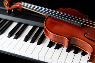 Violin on top of piano keyboard background with copy space for music concept or orchestra concert...