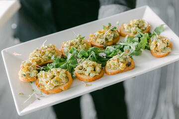 Delicious appetizers served on a platter at a stylish event in a modern venue
