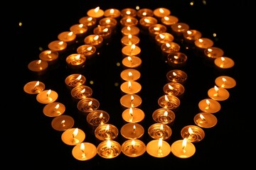 Group of burning church candles in darkness