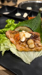 Eating Korean-style grilled meat consisting of meat and vegetables.