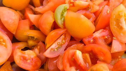 Sliced ​​tomatoes for background. Prepare tomatoes for cooking.