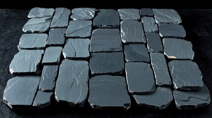 Fototapeta premium Rustic slate tiles arranged neatly on a surface showcasing natural variations and textures