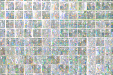 Blurred abstract pastel iridescent colored background with square glass elements.