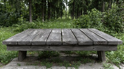 Rustic wooden table in park, green background, product display