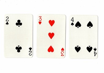 A hand of playing cards showing a run of three on a white background.