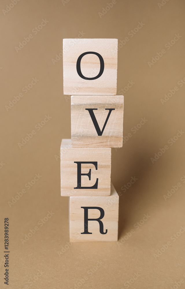 Poster stack of wooden blocks with the word over written on them