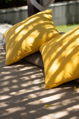 Outdoor Patio Lounge Bed with Yellow Pillows under beautiful shadow