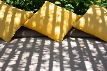 Outdoor Patio Lounge Bed with Yellow Pillows under beautiful shadow