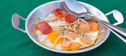 pan-fried egg with pork and toppings. Breakfast food in Thai style