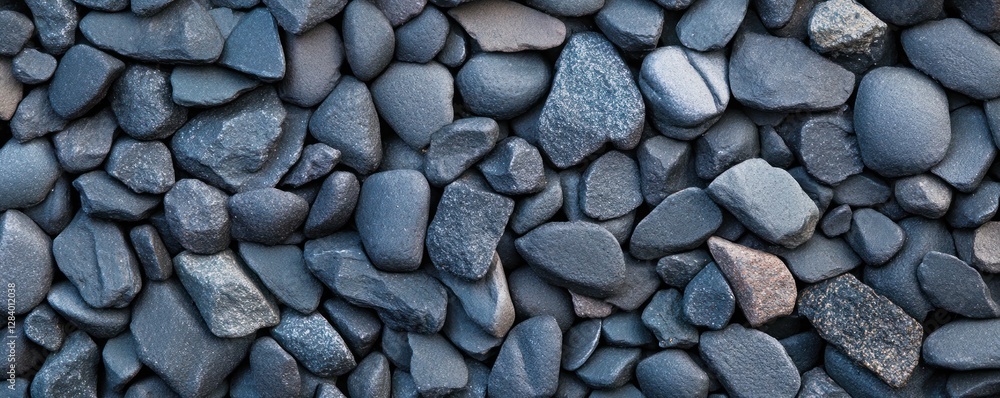Poster background features a textured surface made of varying shapes and sizes of dark stones creating a ri