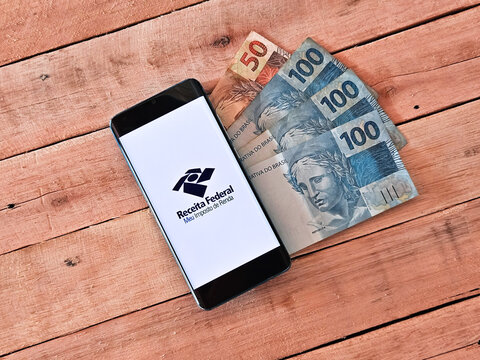 smartphone with Receita Federal - Meu imposto de Renda (Brazilian Federal Revenue Department) logo on screen. Income tax declaration in Brazil.