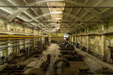 Fototapeta premium Compressor hall in an abandoned power plant for energy generation - Old-fashioned machinery for compression