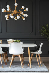 Black dining room with black panel walls, white ceiling, and a large chandelier above the modern wooden table