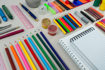 Naklejka premium Concept back to school. creative tools for school creative work on white wooden table.