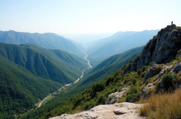 Obraz premium Breathtaking mountain valley view with verdant hills and distant river