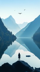 Majestic Mountain Landscape With a Calm Lake and Silhouette of a Person at Sunrise