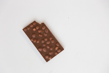  milk chocolate bar with nuts at the bottom, on a white background