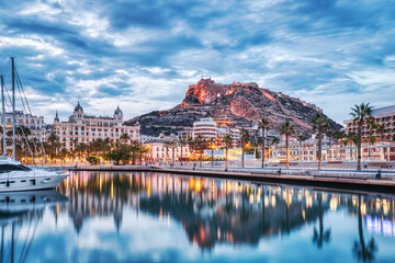 Illuminated Alicante Old Town Panorama at Dusk with Santa Barbara Castle and Harbor