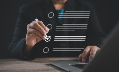 businessman efficiently utilizes a Document Management System (DMS) and task management tools on his laptop He handles assessment forms, questionnaires and checklists, ensuring efficient task tracking