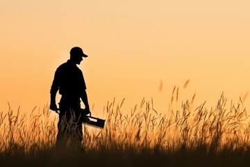 Silhouette of Man Holding Tool Against Vibrant Sunset Landscape