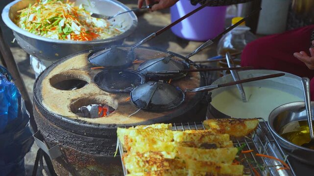 Fresh and tasty. Traditional Vietnamese vegetable pancakes. A close-up view of cooking vegetable pancakes from batter on a heated pan at a street market in Vietnam