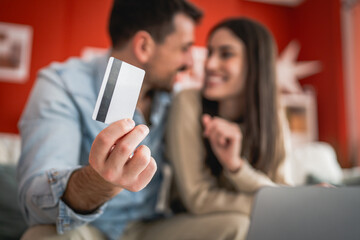 close up on man hand hold credit card for online shopping at home