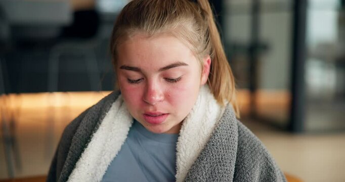 Girl, child and blowing nose on sofa with tissue, blanket and rest for recovery with flu in lounge. Kid, relax and cough with cold, virus or bacteria with congestion, sinus and mucus in family home