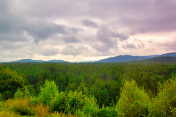 Dramatic clouds form over lush forest fields in Yunnan province, China