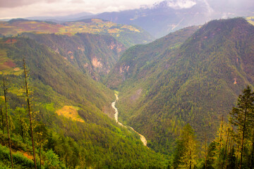Naklejka premium Dramatic clouds form between mountains in Yunnan province, China