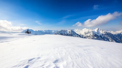 Breathtaking snowy mountain landscape with an expansive white foreground and a clear blue sky filled with clouds : Generative AI