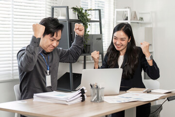 Diverse business partners expressing joy and excitement after achieving success in the office.
