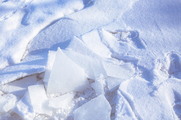 Texture of white snow in the sun