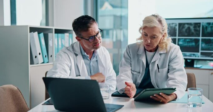 Healthcare, radiology and doctors with tablet for discussion, planning and digital scan for medical diagnosis. Office, mature people and team of radiologist for anatomy, review or laptop for research