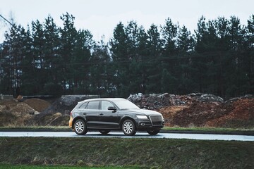 Sleek crossover on scenic route near construction