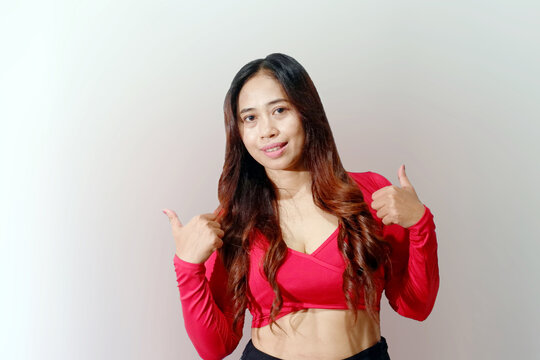Smiling Asian woman showing two thumbs up isolated on a white background