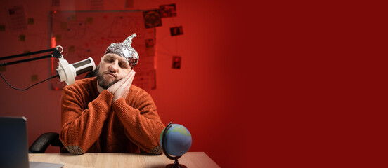 Bearded man in aluminum foil hat, to go to sleep with hands gesture while Live streaming, presenter...