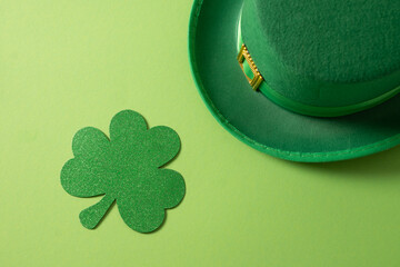 St Patricks day and March 17 concept with green Leprechaun Hat and clover leaf on green background....