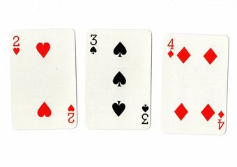 A hand of playing cards showing a run of three on a white background.
